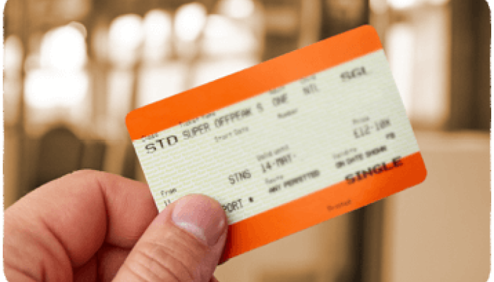 User holding a paper train ticket